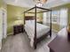 Inviting main bedroom with a four-poster bed, neutral bedding, side tables, and ample natural light from the window at 601 Hillside Dr. N # 4535, North Myrtle Beach, SC 29582