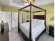Inviting main bedroom with a four-poster bed, neutral bedding, side tables, and ample natural light from the window at 601 Hillside Dr. N # 4535, North Myrtle Beach, SC 29582