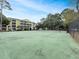Well-maintained community tennis court with lush green surroundings and nearby condominium building at 601 Hillside Dr. N # 4535, North Myrtle Beach, SC 29582