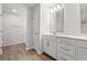 Bright bathroom featuring a double sink vanity with shaker cabinets and a large framed mirror at 632 Woodside Dr., Conway, SC 29526