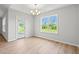 Bright dining area with hardwood floors, a chandelier, and access to the outdoor patio at 632 Woodside Dr., Conway, SC 29526
