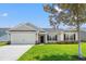 Charming single-story home with manicured lawn, attached garage, and inviting front entrance at 632 Woodside Dr., Conway, SC 29526