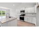Modern kitchen featuring stainless steel appliances, granite countertops, and stylish white cabinets at 632 Woodside Dr., Conway, SC 29526