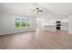 Bright living room featuring hardwood floors, large windows, and an open layout to the kitchen area at 632 Woodside Dr., Conway, SC 29526