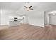 Spacious open-concept living area with wood-look flooring, modern ceiling fan, and ample natural light at 632 Woodside Dr., Conway, SC 29526