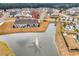 Aerial view of a home on a pond with a fountain, highlighting the serene backyard and neighborhood layout at 725 Salerno Circle # A, Myrtle Beach, SC 29579