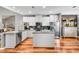 Well-lit kitchen featuring hardwood floors, stainless steel appliances, white cabinetry and granite countertops at 725 Salerno Circle # A, Myrtle Beach, SC 29579