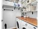 Functional laundry room with white washer and dryer, butcher block countertop, and shelving for storage at 725 Salerno Circle # A, Myrtle Beach, SC 29579