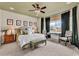 Inviting main bedroom features a decorative ceiling fan, and a sitting area near a large window at 725 Salerno Circle # A, Myrtle Beach, SC 29579