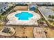 Aerial view of a sparkling community pool, playground, and ample parking surrounded by lush landscaping at 725 Salerno Circle # A, Myrtle Beach, SC 29579