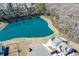 Aerial view of a property showcasing a large pond, surrounding trees, and well-manicured lawns at 780 Old Murrells Inlet Rd., Murrells Inlet, SC 29576