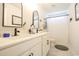 Modern bathroom with double sinks, elegant mirrors, and a shower with a curtain, blending style and functionality at 780 Old Murrells Inlet Rd., Murrells Inlet, SC 29576