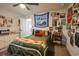Unique bedroom design featuring a bed with colorful tapestry, a ceiling fan, and lots of wall art at 780 Old Murrells Inlet Rd., Murrells Inlet, SC 29576