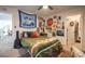 Unique bedroom design featuring a bed with colorful tapestry, a ceiling fan, and lots of wall art at 780 Old Murrells Inlet Rd., Murrells Inlet, SC 29576
