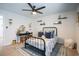 Light and airy bedroom featuring an iron bed frame, makeup vanity, and ceiling fan for comfort and style at 780 Old Murrells Inlet Rd., Murrells Inlet, SC 29576