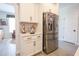 Bright kitchen featuring stainless steel appliances, white cabinets, and a beverage area, ideal for modern living at 780 Old Murrells Inlet Rd., Murrells Inlet, SC 29576