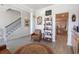 Cozy living room showcasing a decorative rug, leather chair, and open access to the staircase and kitchen at 780 Old Murrells Inlet Rd., Murrells Inlet, SC 29576