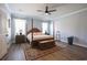 A comfortable primary bedroom featuring wood floors, a four poster bed, ceiling fan, and white trim at 780 Old Murrells Inlet Rd., Murrells Inlet, SC 29576