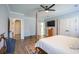 The main bedroom offers wood floors, a ceiling fan, a view of the en suite, and a chest of drawers with tv at 780 Old Murrells Inlet Rd., Murrells Inlet, SC 29576