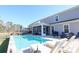 Inviting backyard pool area with lounge chairs, screened porch, perfect for relaxation and entertaining at 780 Old Murrells Inlet Rd., Murrells Inlet, SC 29576