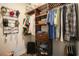Walk-in closet features custom wooden shelving, hanging racks, and a spot for storing suitcases at 780 Old Murrells Inlet Rd., Murrells Inlet, SC 29576