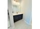 Bathroom with a black vanity, stylish lighting, and tile flooring at 8628 Farrier Dr., Myrtle Beach, SC 29588