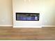 Modern linear fireplace with blue flame effect set in a neutral wall at 8628 Farrier Dr., Myrtle Beach, SC 29588