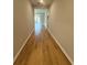 Long hallway featuring wood-look floors, leading to various rooms in the home at 8628 Farrier Dr., Myrtle Beach, SC 29588