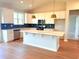 Bright kitchen with white cabinets, an island, stainless appliances, and stylish blue backsplash at 8628 Farrier Dr., Myrtle Beach, SC 29588