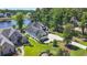 Aerial view showcasing a waterfront home with pristine landscaping and a circular driveway at 9785 Anchor Dr., Longs, SC 29568