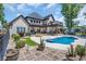 Beautiful backyard with pool, lounge chairs, and manicured garden at 9785 Anchor Dr., Longs, SC 29568