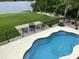 An inviting backyard featuring a swimming pool, a fire pit, and views of the waterfront at 9785 Anchor Dr., Longs, SC 29568