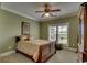 Comfortable bedroom with a large window and plantation shutters at 9785 Anchor Dr., Longs, SC 29568