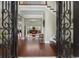 Inviting foyer with hardwood floors, wrought iron door, staircase, and open view to a cozy sitting room at 9785 Anchor Dr., Longs, SC 29568
