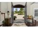 Elegant foyer with hardwood floors and ornate front doors opening to a landscaped yard at 9785 Anchor Dr., Longs, SC 29568