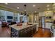 Open-concept kitchen with granite island, stainless appliances, and hardwood floors at 9785 Anchor Dr., Longs, SC 29568