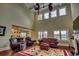 Spacious living room with vaulted ceilings, fireplace, plush seating, and seamless transition to the kitchen at 9785 Anchor Dr., Longs, SC 29568
