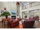 Open living room with a fireplace, built-in shelving, adjacent dining area, and comfortable seating at 9785 Anchor Dr., Longs, SC 29568