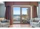 Balcony view overlooking the beach, lounge chairs, and decorative curtains at 100 N Beach Blvd. # 1608, North Myrtle Beach, SC 29582