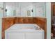 A luxurious soaking tub with jets and bronze tile accents at 100 N Beach Blvd. # 1608, North Myrtle Beach, SC 29582