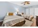 This bedroom features two twin beds, light blue walls, ceiling fan, and wood floors at 100 N Beach Blvd. # 1608, North Myrtle Beach, SC 29582