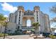 Stunning multi-story building showcasing unique architectural design with arched entrance and ample parking at 100 N Beach Blvd. # 1608, North Myrtle Beach, SC 29582