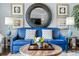This living room features a blue sofa with decorative pillows, wood floors, and neutral paint at 100 N Beach Blvd. # 1608, North Myrtle Beach, SC 29582