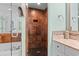Walk-in shower has brown tiling, pebble floor, and built-in storage niche at 100 N Beach Blvd. # 1608, North Myrtle Beach, SC 29582