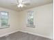 Neutral bedroom featuring carpeted floors, two windows, and a ceiling fan with a light fixture at 1019 Prince St., Georgetown, SC 29440