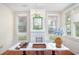 Dining room featuring a decorative fireplace, hardwood floors, built-in benches, and natural light from multiple windows at 1019 Prince St., Georgetown, SC 29440