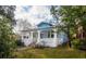 Angle view of a charming blue house with a welcoming front porch and mature trees at 1019 Prince St., Georgetown, SC 29440