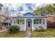 Charming blue house with a welcoming front porch and beautifully landscaped front yard at 1019 Prince St., Georgetown, SC 29440