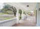 Inviting front porch featuring classic columns, white brick details, and wood flooring at 1019 Prince St., Georgetown, SC 29440