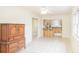Open-concept living area flows into the kitchen, featuring tile floors and a large armoire at 1019 Prince St., Georgetown, SC 29440